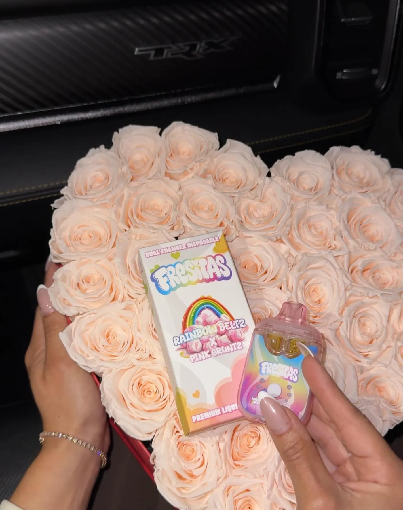 Rainbow Beltz and Pink Gruntz Fresitas product beside a pale rose arrangement